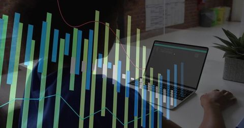 Female developer analyzing data with laptop at office desk