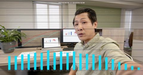 Asian Professional Recording Revenue Overview Video in Modern Office Cubicle