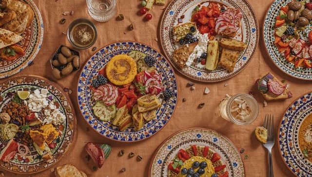 Mediterranean mezze feast with polenta cake on hand-painted ceramic plates