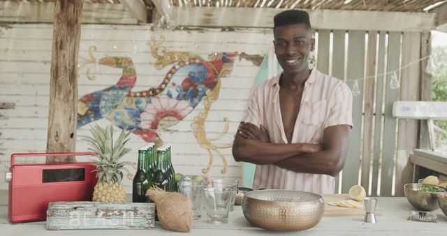 Smiling Man Preparing Drinks Near Beach Bar Decorated with Colorful Mural - Download Free Stock Images Pikwizard.com