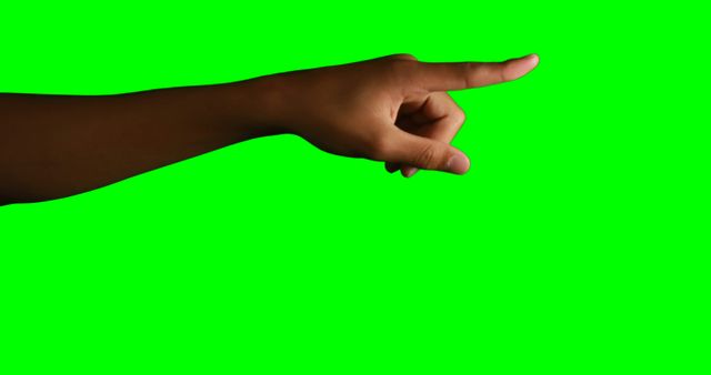 Hand of woman pointing against green screen