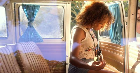 Young Woman Relaxing in Van at Outdoor Festival
