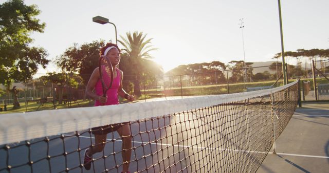 Woman Playing Tennis in the Evening Sunlight on Outdoor Court - Download Free Stock Images Pikwizard.com