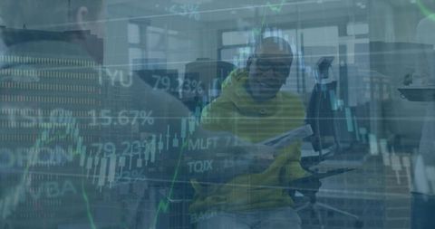 Office team analyzing market data with man in yellow hoodie holding tablet and papers