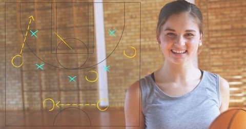 Female Basketball Player Strategizing with Court Diagram