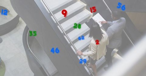 Executives ascending staircase discussing documents with augmented data markers in atrium