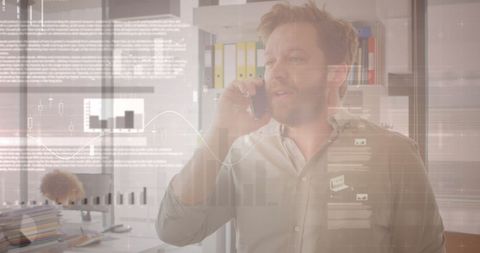 Businessman Analyzing Data While Using Smartphone in Office