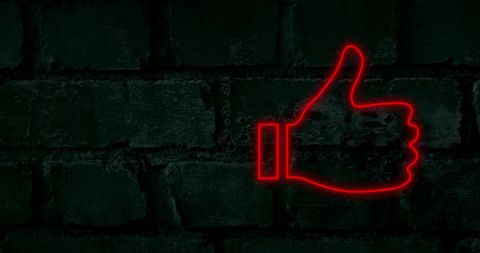 Red Neon Thumbs Up Sign on Black Brick Wall