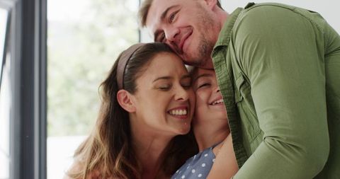 Family sharing joyful moment in celebration with affectionate hugs