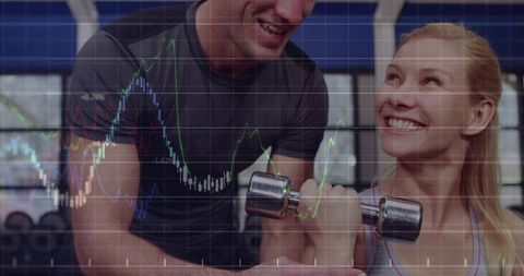Woman curling chrome dumbbell while trainer spotting with financial analytics overlay