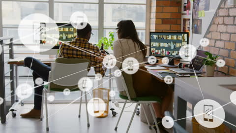 Creative Team Analyzing Data with Technology Icons Overlay