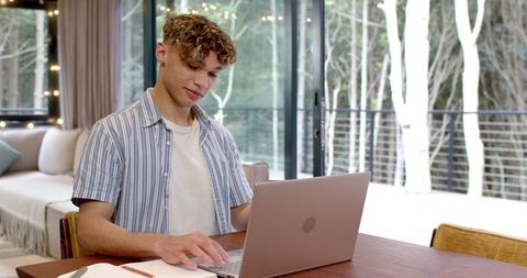 Young Professional Working on Laptop in Modern Home Environment