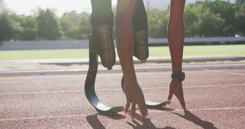 Athlete with Prosthetic Legs Ready to Sprint