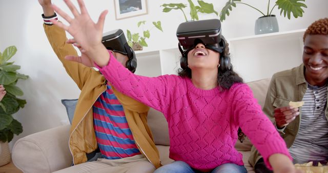 Kids sitting on a sofa and experiencing virtual reality with VR headsets, displaying expressions of excitement and joy. Ideal for illustrating modern technology use among children, advertising VR products, or creating content about home entertainment and family fun.