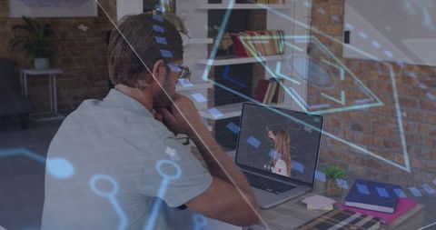 Man Engaged in Virtual Learning with Digital Interface
