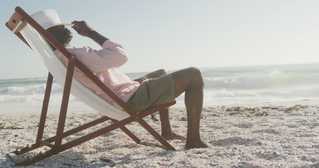 Man Relaxing on Beach Chair Enjoying Coastal Breeze - Download Free Stock Images Pikwizard.com