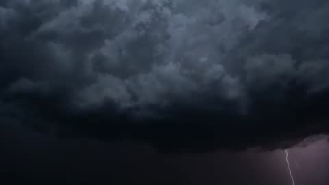 Lightning Bolt Piercing Storm Clouds Captured over Open Plain