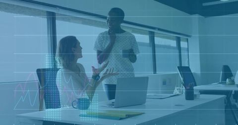 Collaborating office colleagues discussing strategies in modern workspace