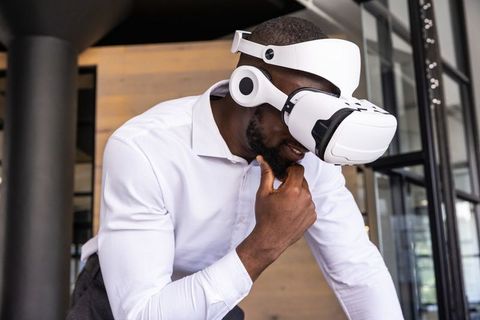 Innovative Professional Engaging with VR Technology in Modern Workspace