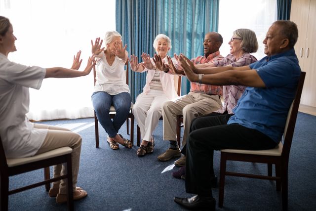 Seniors participating in a group exercise session with a female doctor in a retirement home. They are seated on chairs, engaging in physical activity, promoting health and wellness. Ideal for use in healthcare, senior living, and wellness promotions, as well as illustrating active aging and community activities in retirement homes.
