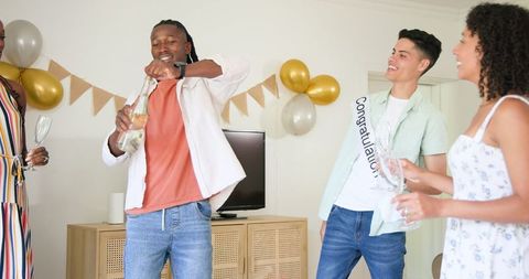 Friends Celebrating with Champagne at Festive Home Gathering