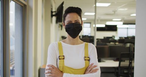 Confident Businesswoman Wearing Face Mask in Contemporary Office
