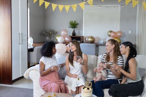 Women Friends Celebrating Birthday in Cozy Living Room