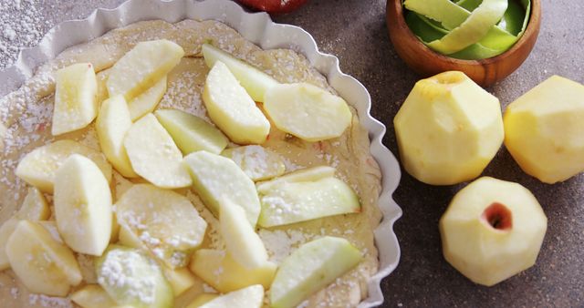 Ideal for blogs or publications about baking or cooking. Useful for websites and social media posts focused on homemade desserts and recipes. Can be used in educational materials or cookbooks illustrating the process of preparing apple tart.