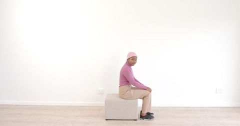 Minimalist Fashion Shot Shell of Stylish Pink and Tan Ensemble against White