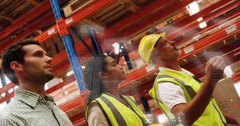 Warehouse Team Discussing Inventory with Safety Helmets