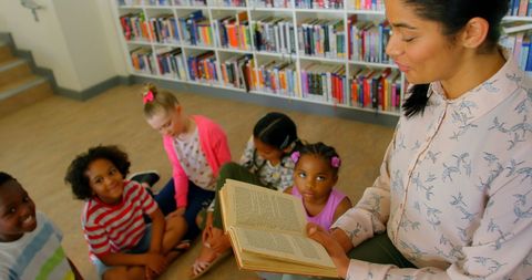 Teacher Guiding Young Students in a Library Storytime - Download Free Stock Images Pikwizard.com