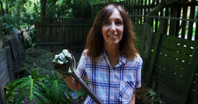 Smiling Woman Gardening with Shovel in Backyard - Download Free Stock Images Pikwizard.com