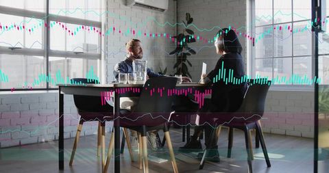 Discussing financial data with animated stock charts in modern office boardroom meeting