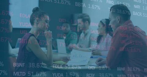 Team Analyzing Financial Data with Overlaid Graphs in Conference Room