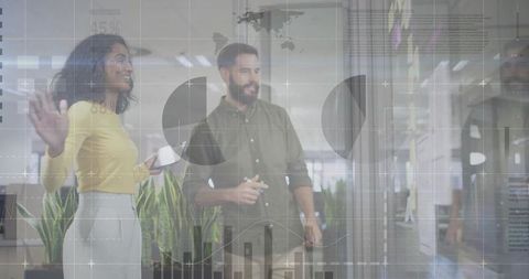 Colleagues strategizing with charts in open office setting
