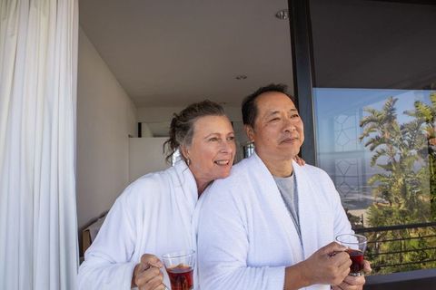 Senior couple relaxing on balcony with ocean view