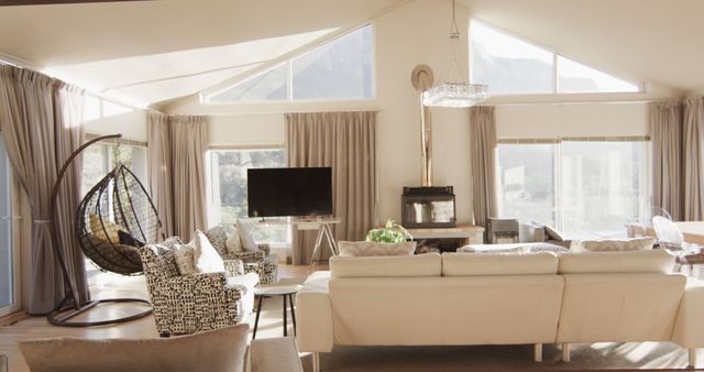 Panning shot of furnished living room home interior with large sunny windows. Lounge, home, interior design, luxury, domestic life and lifestyle, unaltered.