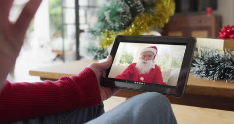 Virtual Christmas Video Call with Santa Claus on Tablet at Home