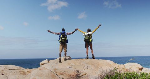 Adventurous Couple Embracing Freedom on Coastal Hiking Trip