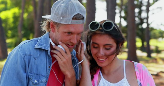 Couple listening to headphones at festival 