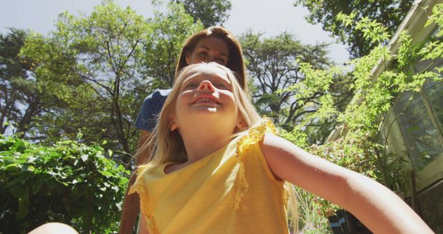 Mother and daughter enjoying summer day in lush garden outdoors - Download Free Stock Images Pikwizard.com