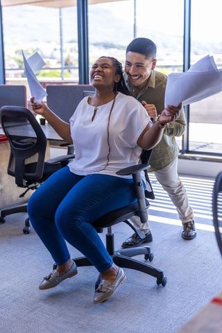 Unstoppable coworkers celebrating team spirit in modern office