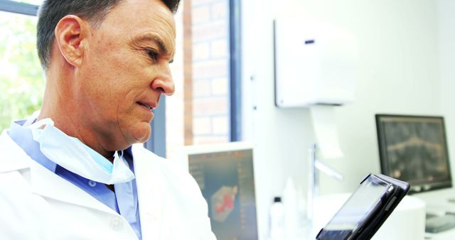 Male Doctor Using A Tablet for Medical Records in Hospital Office - Download Free Stock Images Pikwizard.com