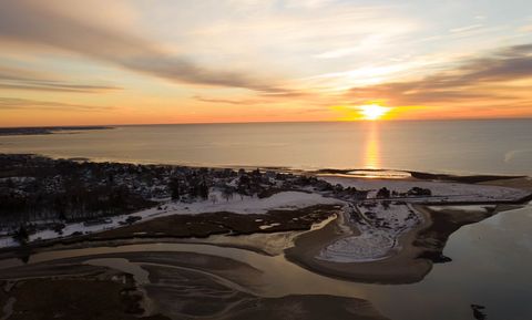 Stunning Coastal Sunset Over Snowy Towns and Serene Waters