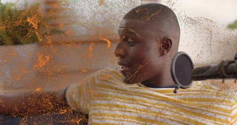 Reclining podcaster recording casual home podcast on sofa with microphone and pop filter