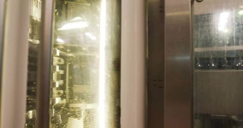 Industrial chamber with glass acrylic covered in droplets and fluorescent tube