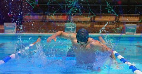 Competitive male swimmer performing butterfly stroke in pool