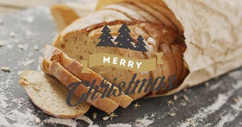 Festive Merry Christmas rustic sliced artisan bread wrapped in parchment on floured slate