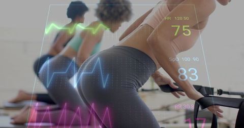 Reformer pilates group training with augmented reality biometric overlay and wearable data