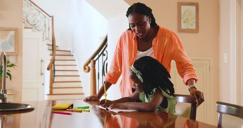 Mother Helping Daughter with Homework in Bright Home